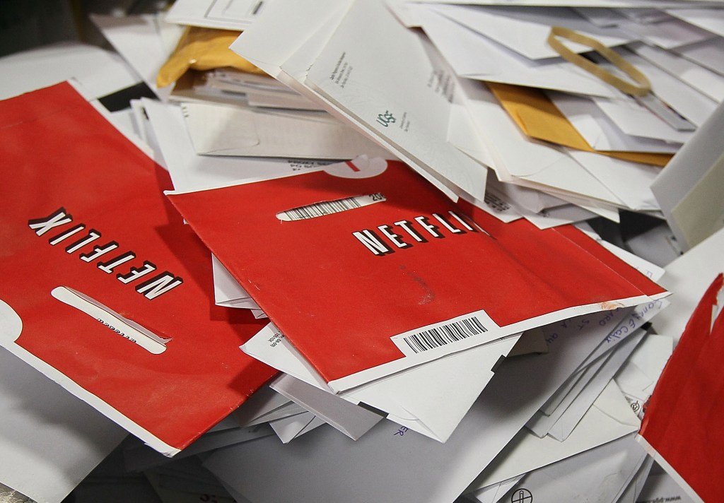 Netflix DVDs in a big pile of mail