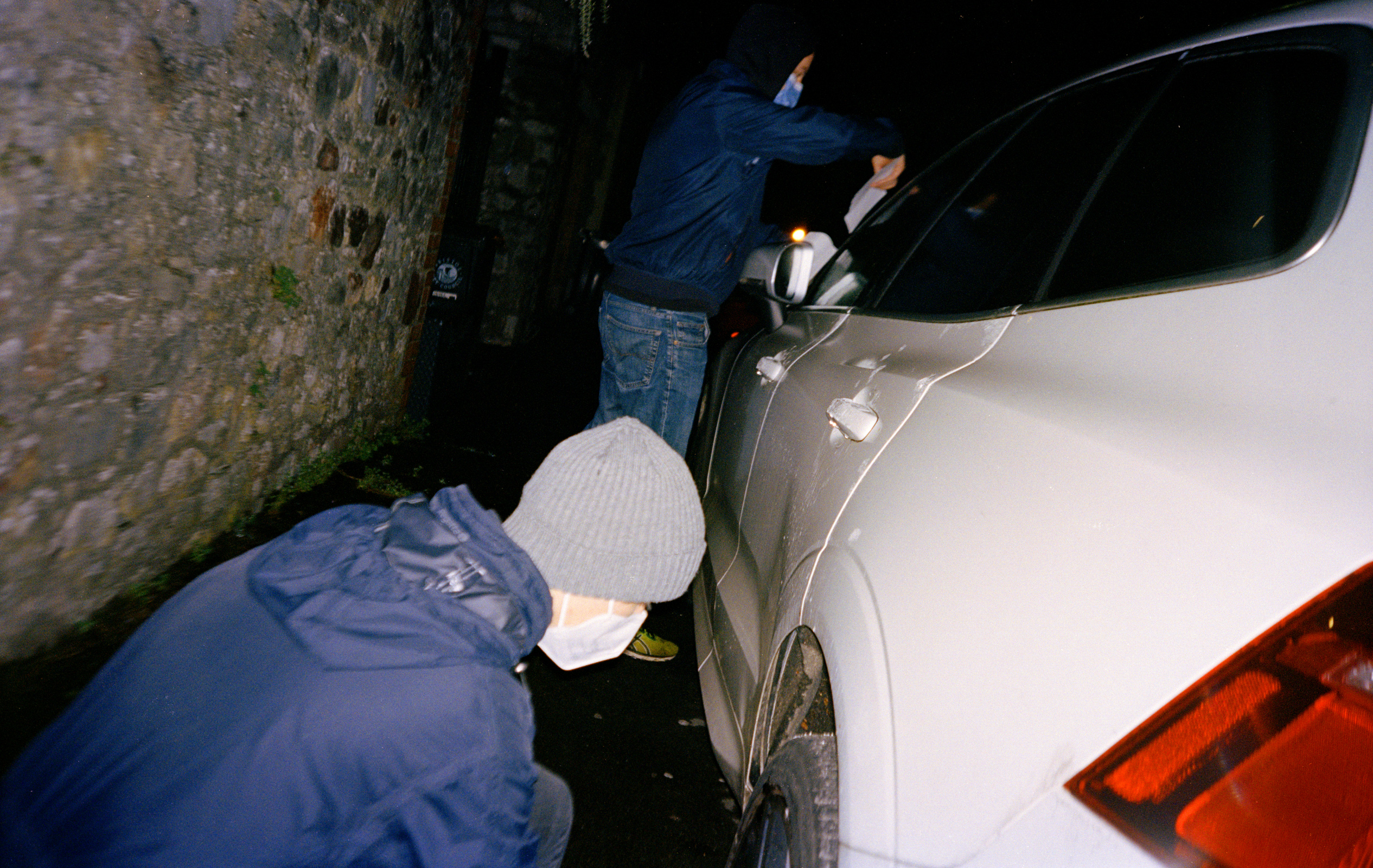 Tyre Extinguishers in Bristol: Two activists next to an SUV