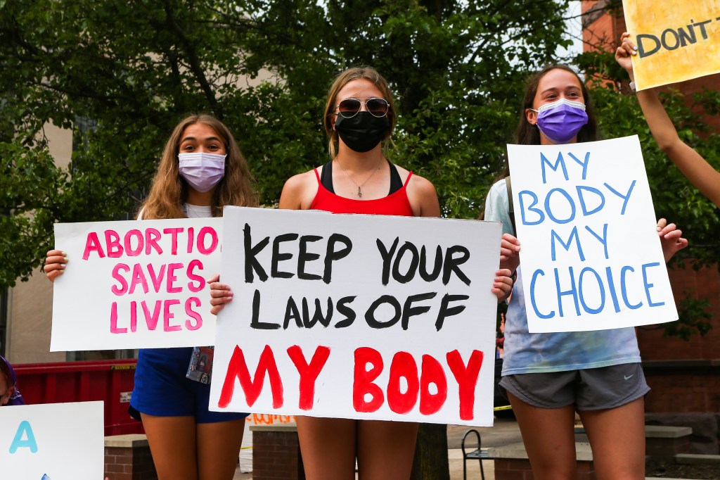 Abortion-rights protesters hold placards during a rally at the Columbia County courthouse in Pennsylvania.