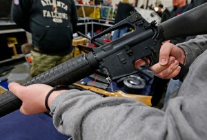 A man holds a Bushmaster AR-15 Model A2 semi-automatic assault rifle