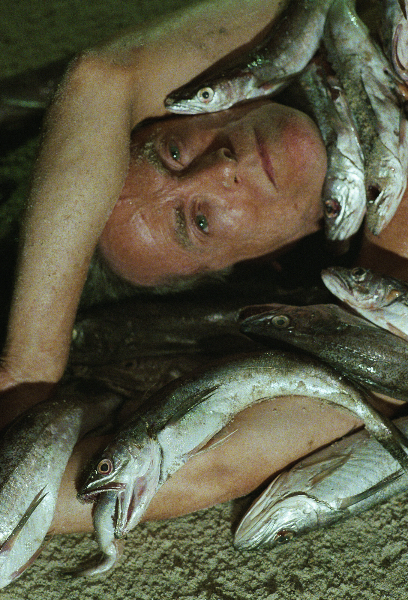 Fire Island: An older gay man covered in fish, photography by Matthew Leifheit from To Die Alive