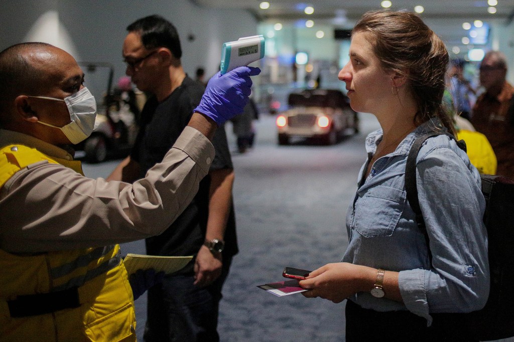 A health officer uses a thermal head to detect a monkeypox virus on arriving passengers at Soekarno-Hatta International Airport in Tangerang near Jakarta, Indonesia on May 15, 2019.(Jepayona Delita/Future Publishing via Getty Images)