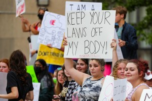 Abortion-rights protesters hold placards during a rally in Pennsylvania.