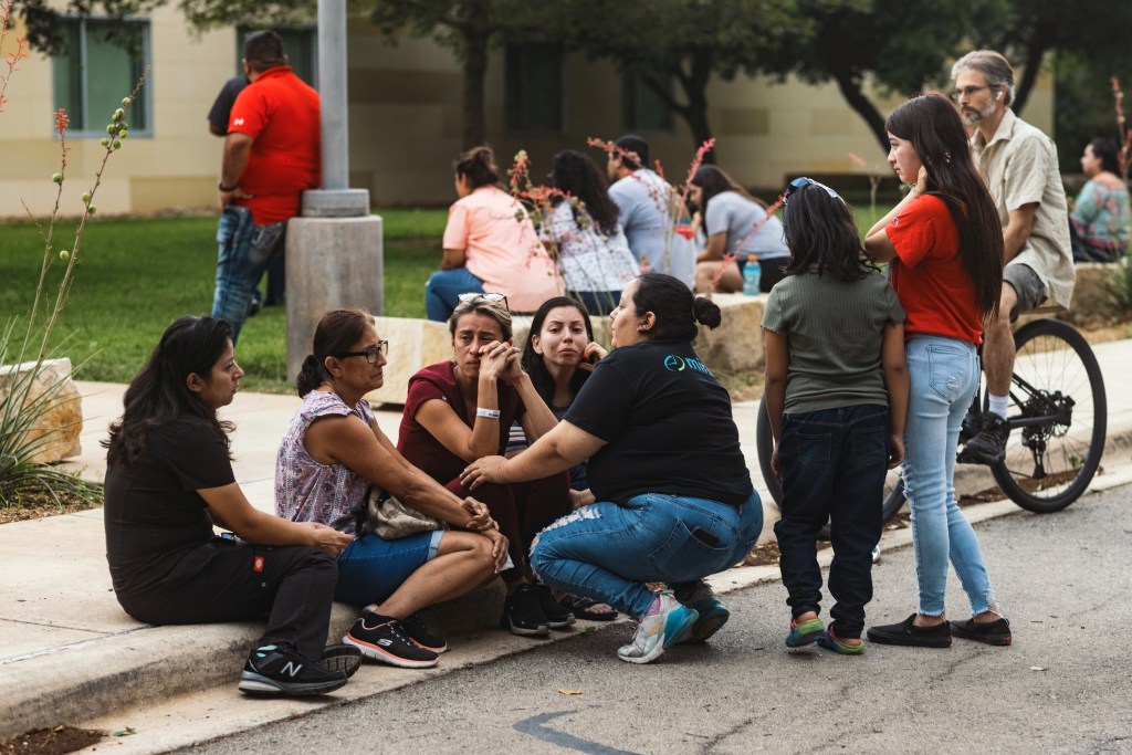 People grieve outside the SSGT Willie de Leon Civic Center, where the community has gathered in the wake of a mass shooting at Robb Elementary School on May 24, 2022 in Uvalde, Texas.