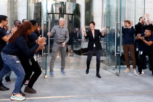 Tim Cook and Deirdre O'Brien leaving an apple store, crowds are applauding them.