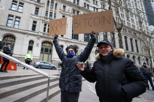 People hold up signs