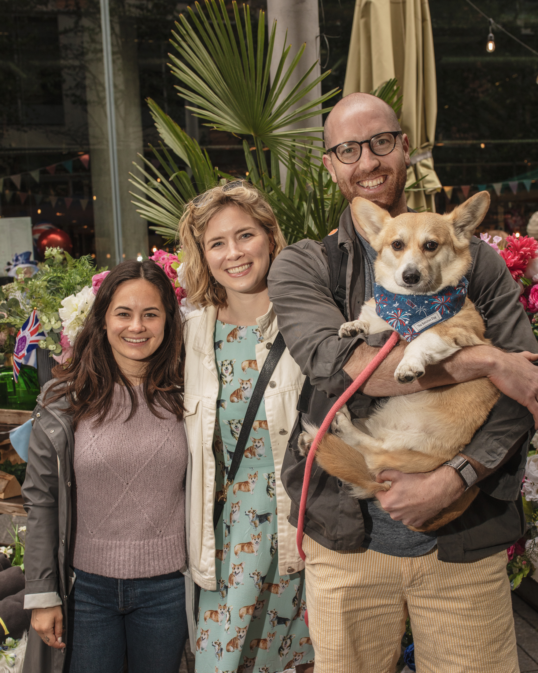 A family holding up their corgi at the London corgi cafe for Platinum Jubilee