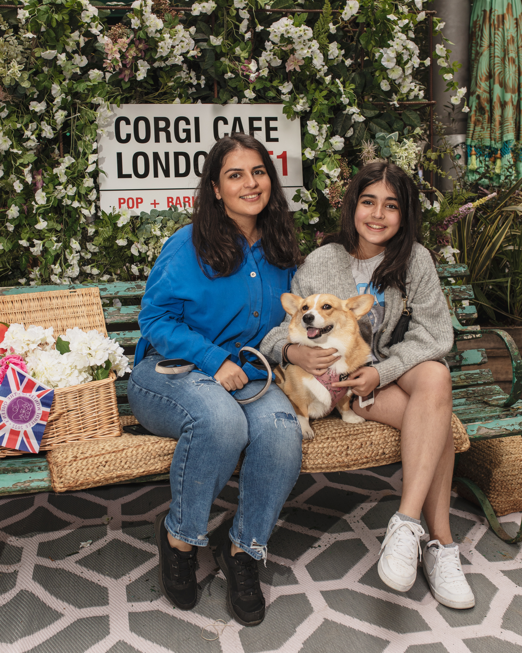 A mother and daughter with their corgi at the London corgi cafe for Platinum Jubilee