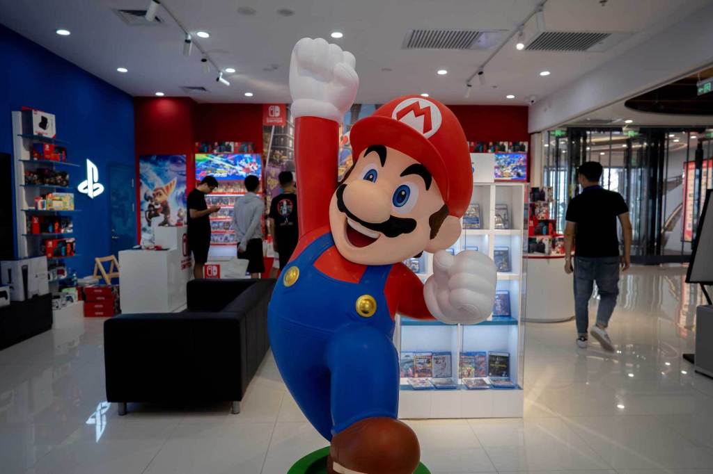 Mario pumping his fist in the air in a store, with an uncomfortably hypercapitalist energy.