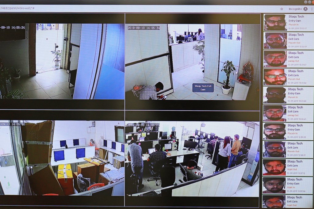 A screen showing views from four surveillance cameras in an office building, with a list of identified faces on the right