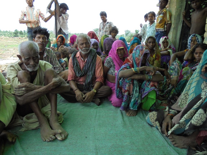 Villagers gather to tell Murphy the story of the revolt