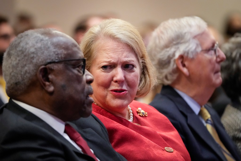 Associate Supreme Court Justice Clarence Thomas sits with his wife and conservative activist Virginia Thomas while he waits to speak at the Heritage Foundation on October 21, 2021 in Washington, D.C.