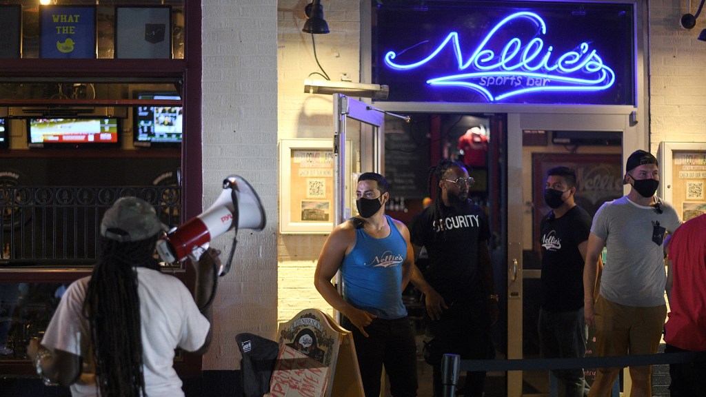 Black LGBTQ activists protest outside of Nellie's Sports Bar in Washington, D.C.