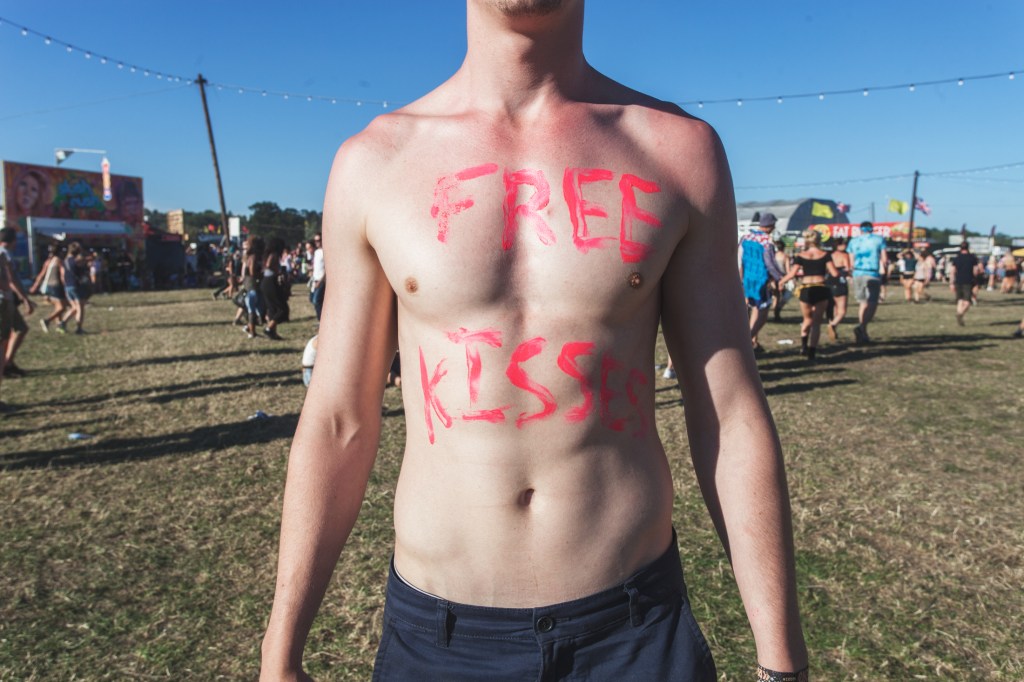 Topless man with "free kiss" on his chest during heatwave