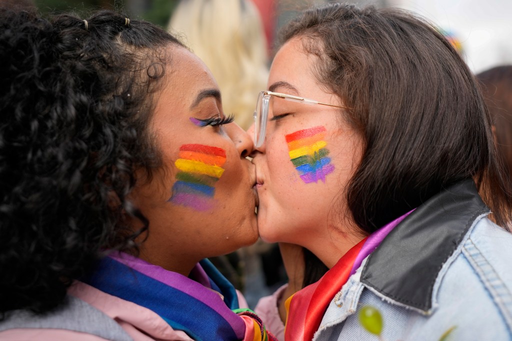 Parcicipants kiss during the annual Gay Pride Parade in Sao Paulo, Brazil, Sunday, June 19, 2022.