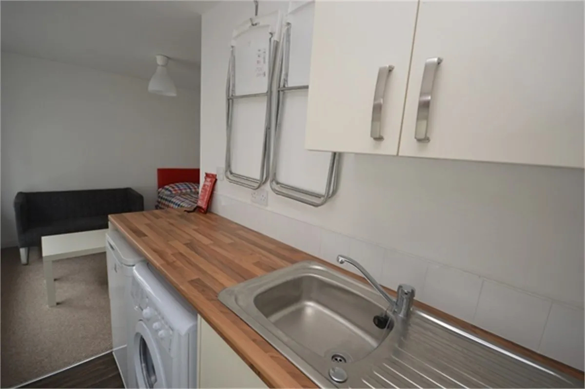 Cramped kitchen with two folding chairsin one-bed studio to rent in Sunderland