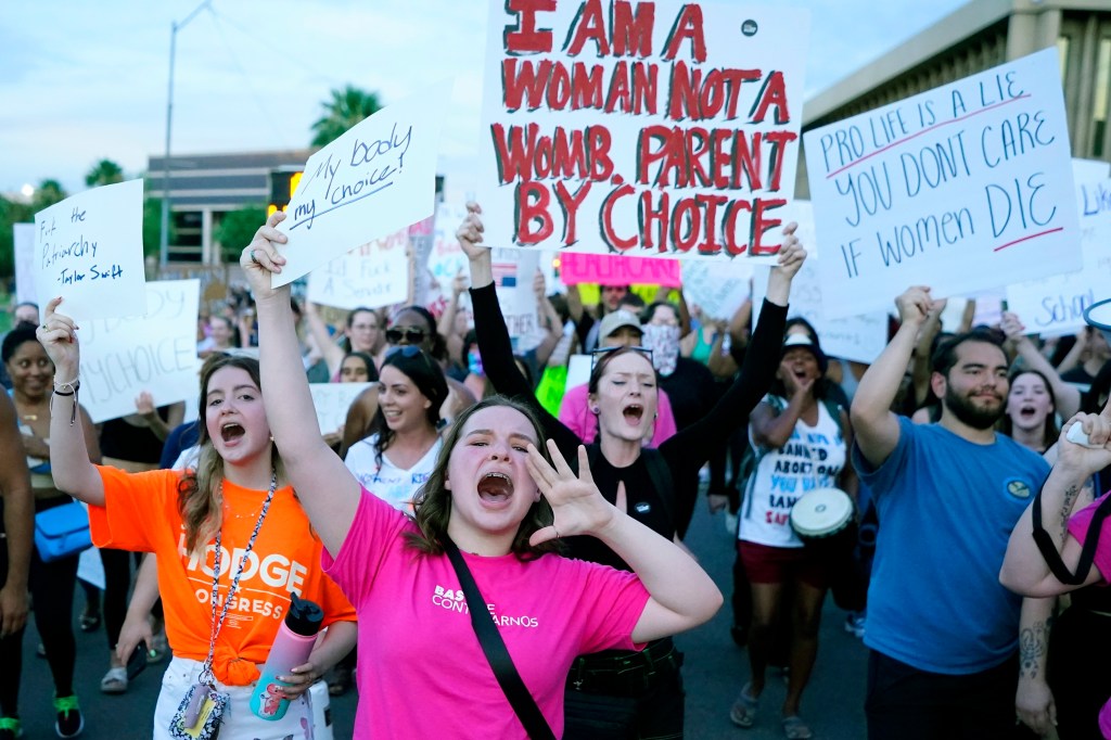 Protesters march around the Arizona Capitol after the Supreme Court decision to overturn the landmark Roe v. Wade abortion decision Friday, June 24, 2022, in Phoenix.