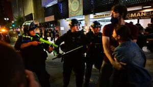 Police holding rubber-bullet guns and batons move to disperse a crowd of abortion-rights activists protesting after the fall of Roe v. Wade in Los Angeles on Friday.