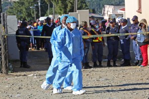 Forensic experts work outside the  Enyobeni Tavern.