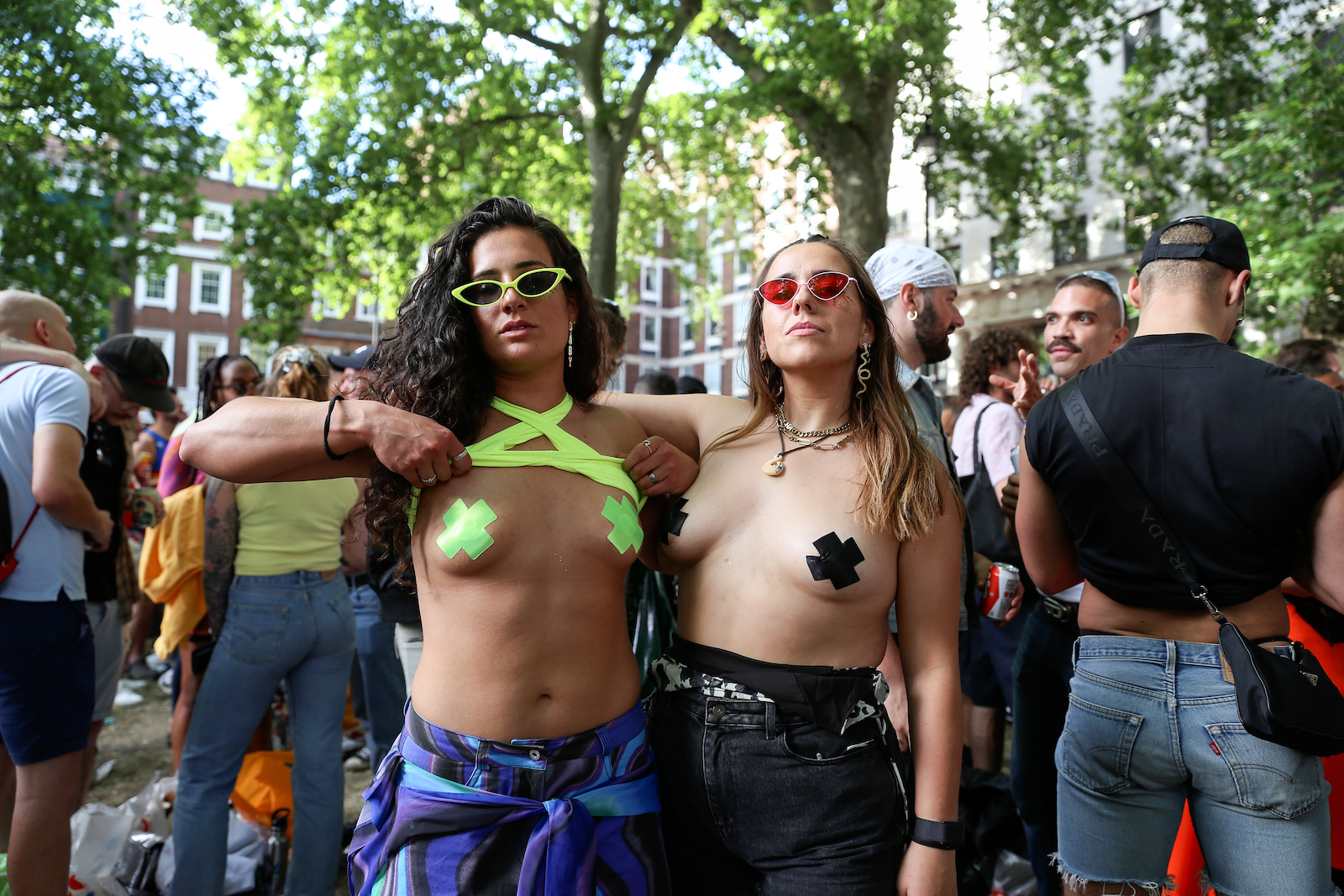 Two London Pride attendees with nipple tape in Soho