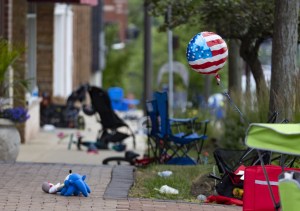 Chairs, bicycles, strollers and balloons were left behind at the scene of a mass shooting on the Fourth of July parade route Monday, July 4, 2022, along Central Avenue in Highland Park, Illinois.