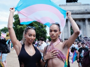 Munroe Bergdof and another protester holding a trans flag at London Trans+ Pride