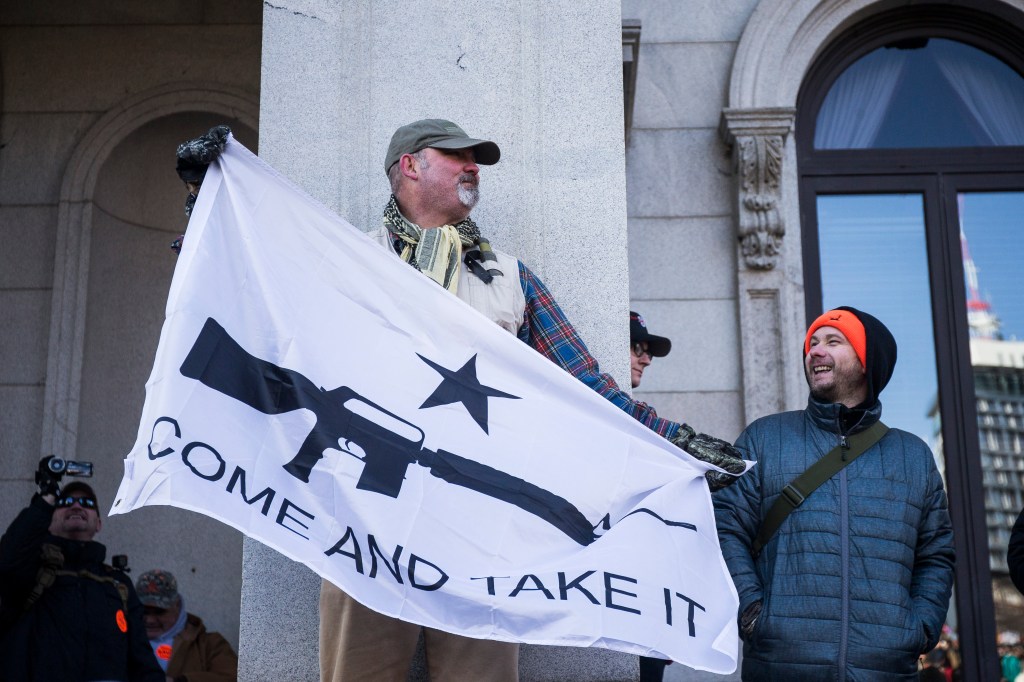 Gun rights advocates hold a flag during a rally organized by The Virginia Citizens Defense League on Capitol Square near the state capitol building on January 20, 2020 in Richmond, Virginia. (Photo by Zach Gibson/Getty Images)