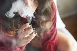 A woman smokes a Juul