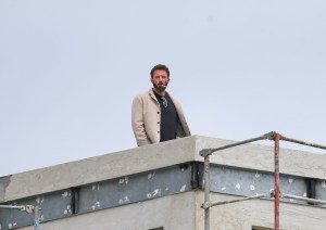 An image of Ben Affleck smoking a cigarette on the roof of an unfinished building.