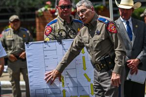 Director and Colonel of the Texas Department of Public Safety Steven C. McCraw speaks at a press conference using a crime scene outline of the Robb Elementary School showing the path of the gunman, outside the school in Uvalde, Texas, on May 27, 2022.