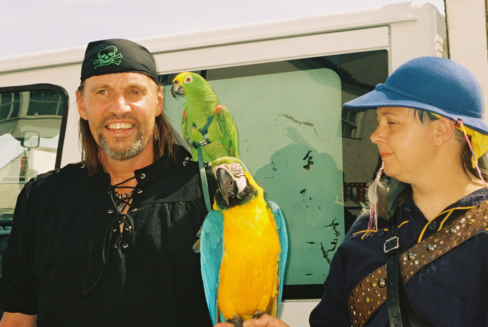 Two pirate fanatics and two parrots on 'Pirate Day' in Hastings