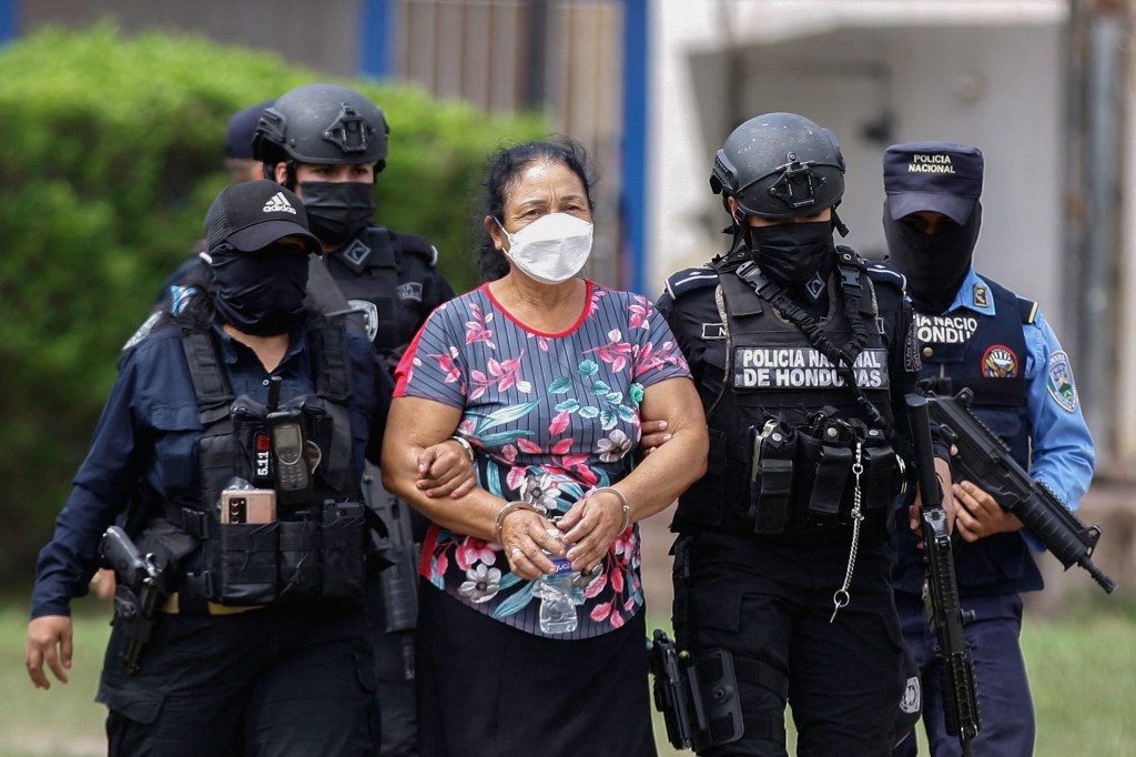 Members of the Honduran Special Forces escort Honduran alleged drug trafficer Herlinda Bobadilla, upon her arrival in Tegucigalpa, on May 15, 2022.