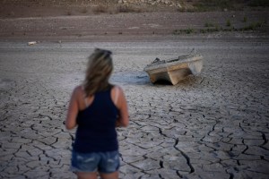 a formerly sunken boat now on cracked earth hundreds of feet from what is now the shoreline on Lake Mead at the Lake Mead National Recreation Area