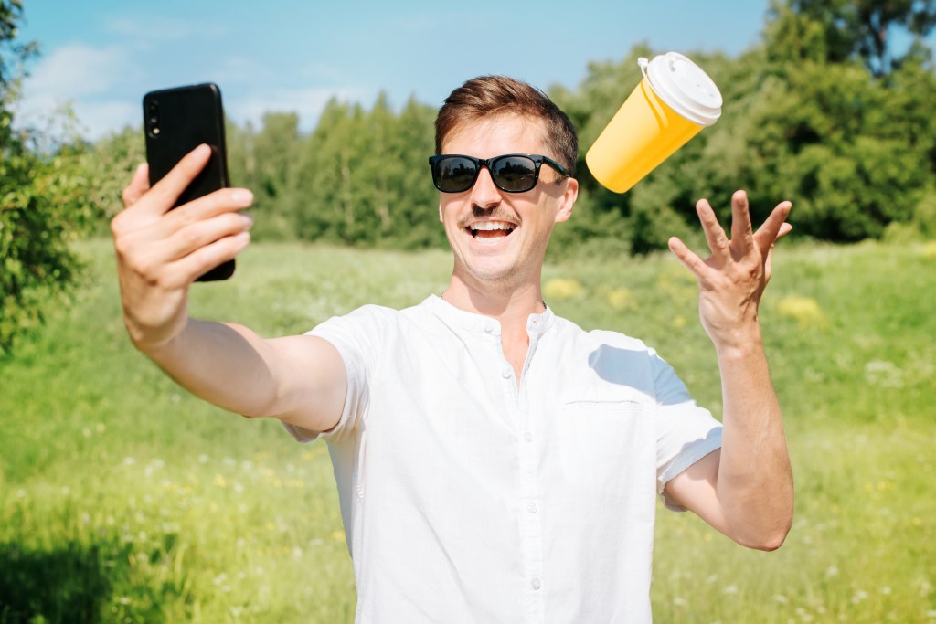 un homme avec le sourire et une boisson chaude