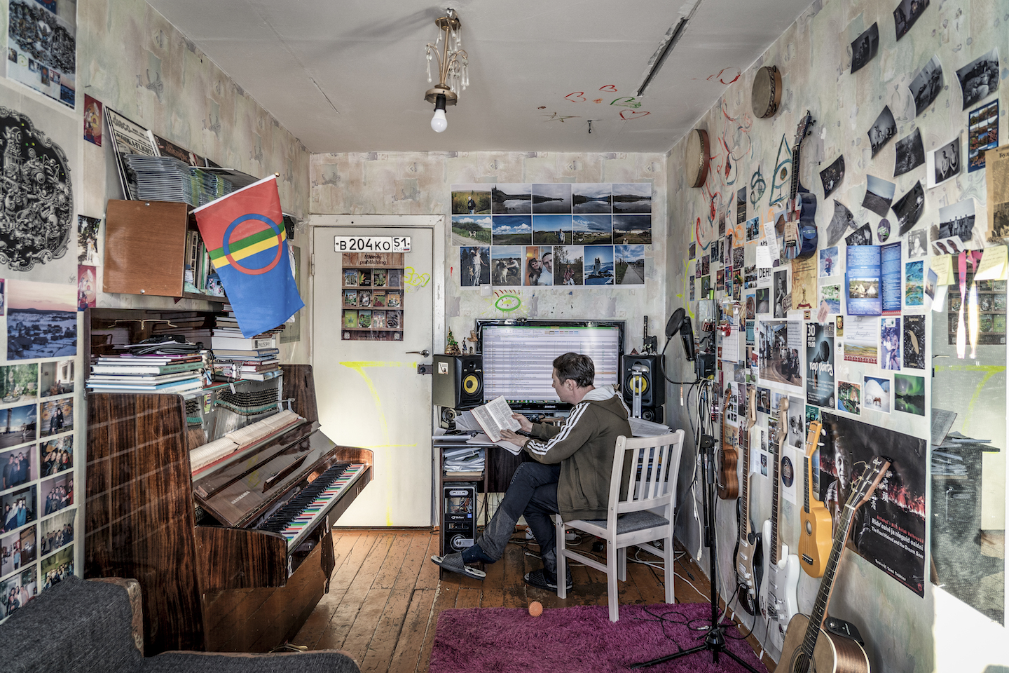 A man reads in a music studio.