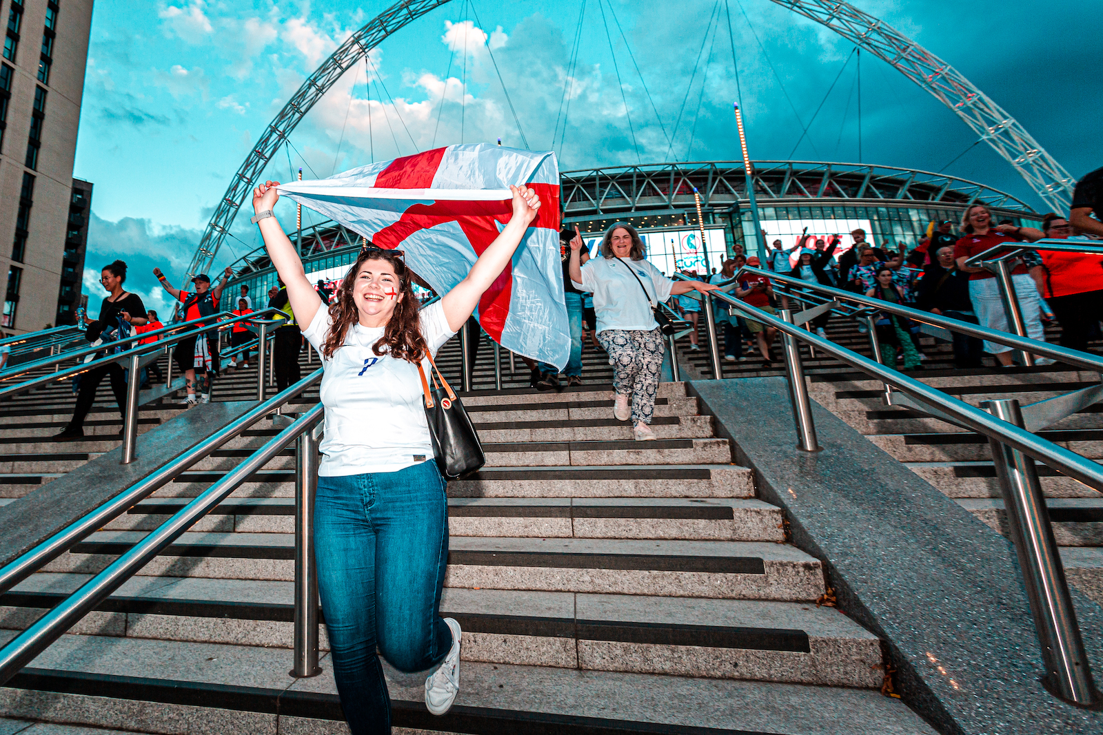 Joyful football fans outside Wembley Stadium following the Women's Euro 2022 Final