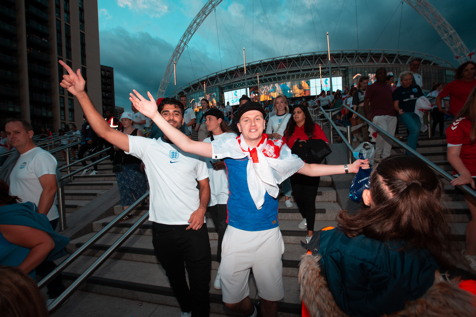 Joyful football fans outside Wembley Stadium following the Women's Euro 2022 Final