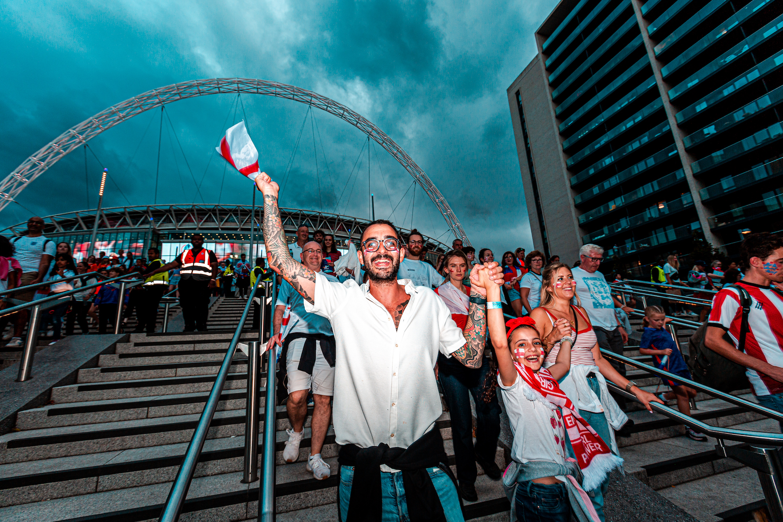 Joyful football fans outside Wembley Stadium following the Women's Euro 2022 Final