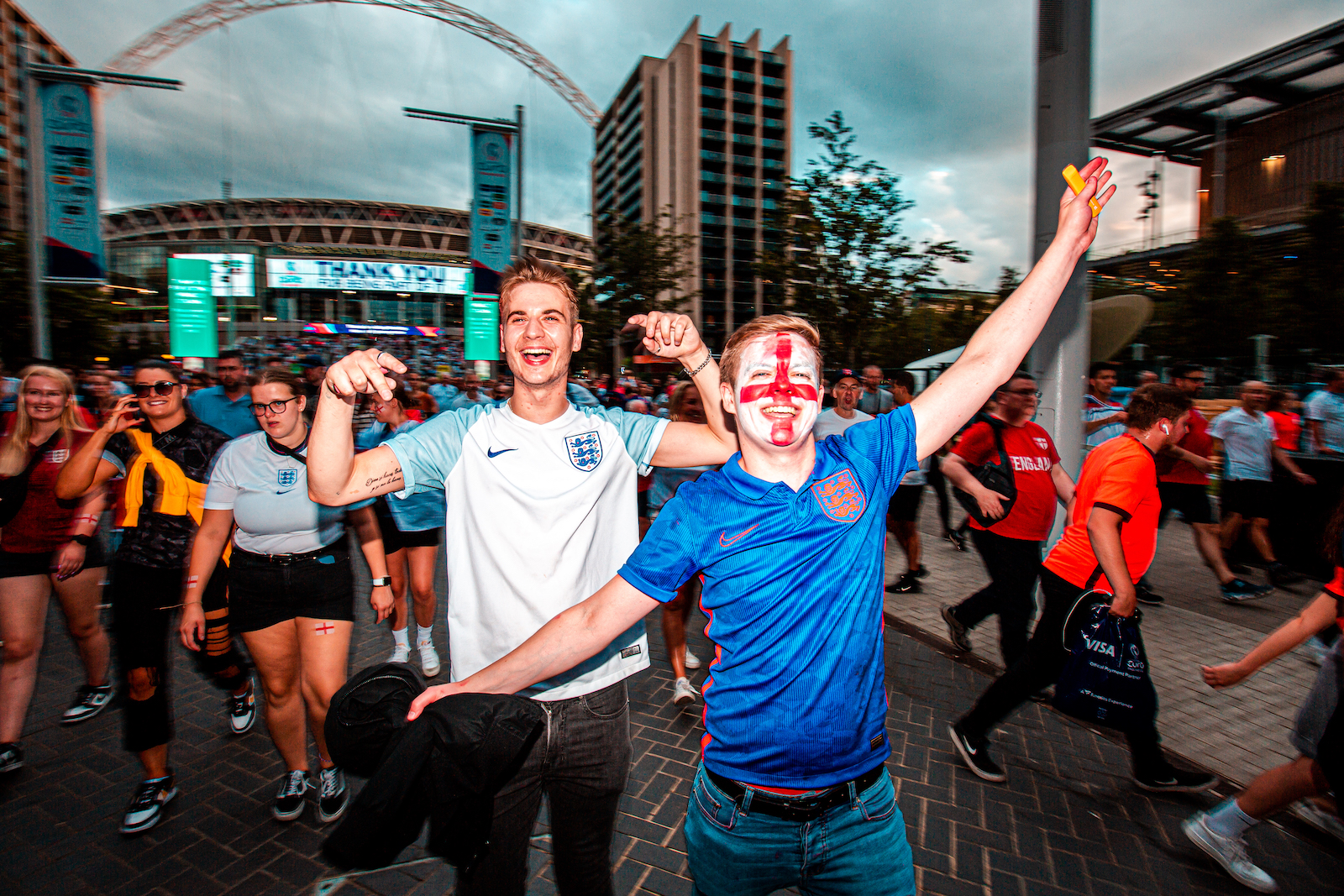 Joyful football fans outside Wembley Stadium following the Women's Euro 2022 Final