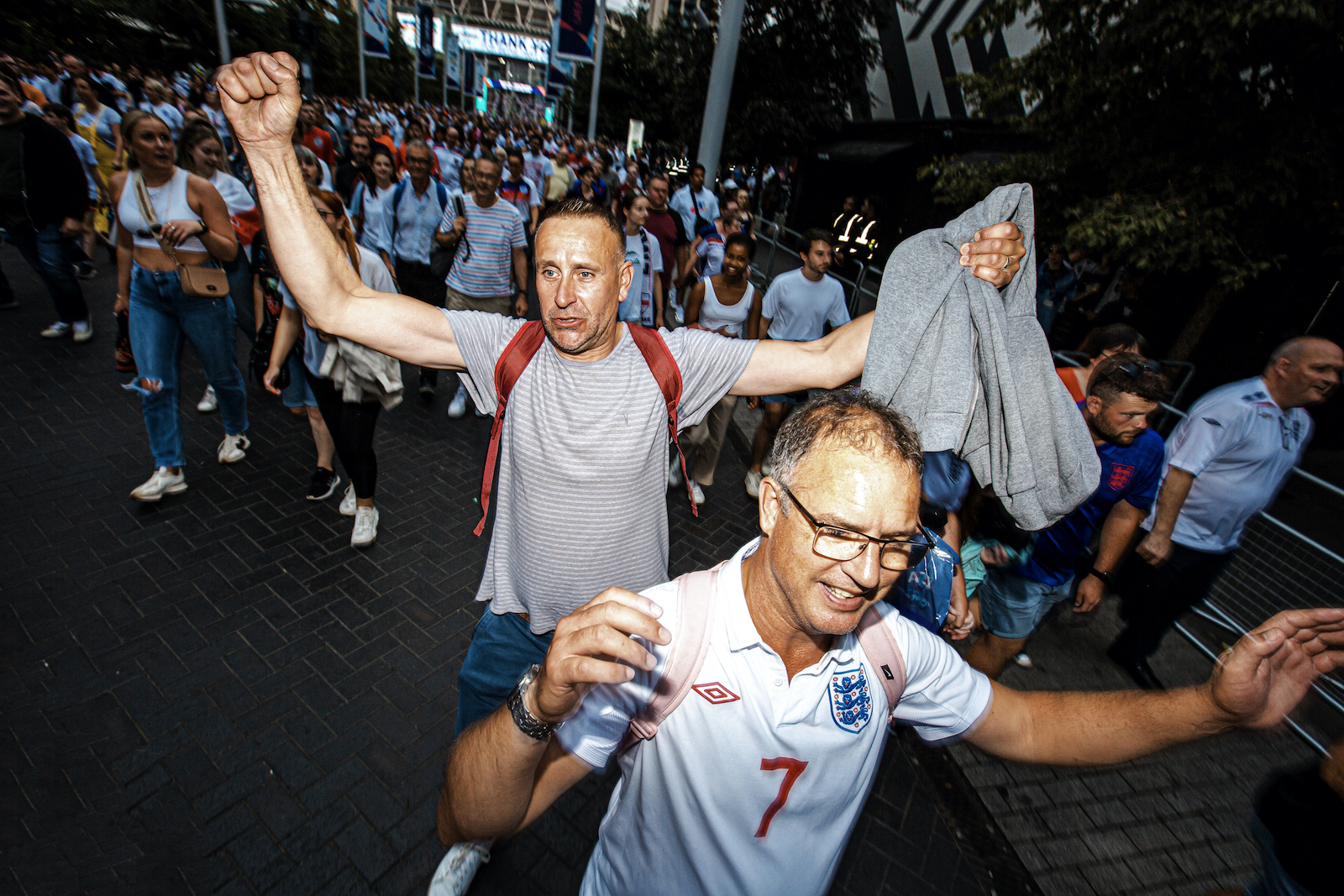 Joyful football fans outside Wembley Stadium following the Women's Euro 2022 Final