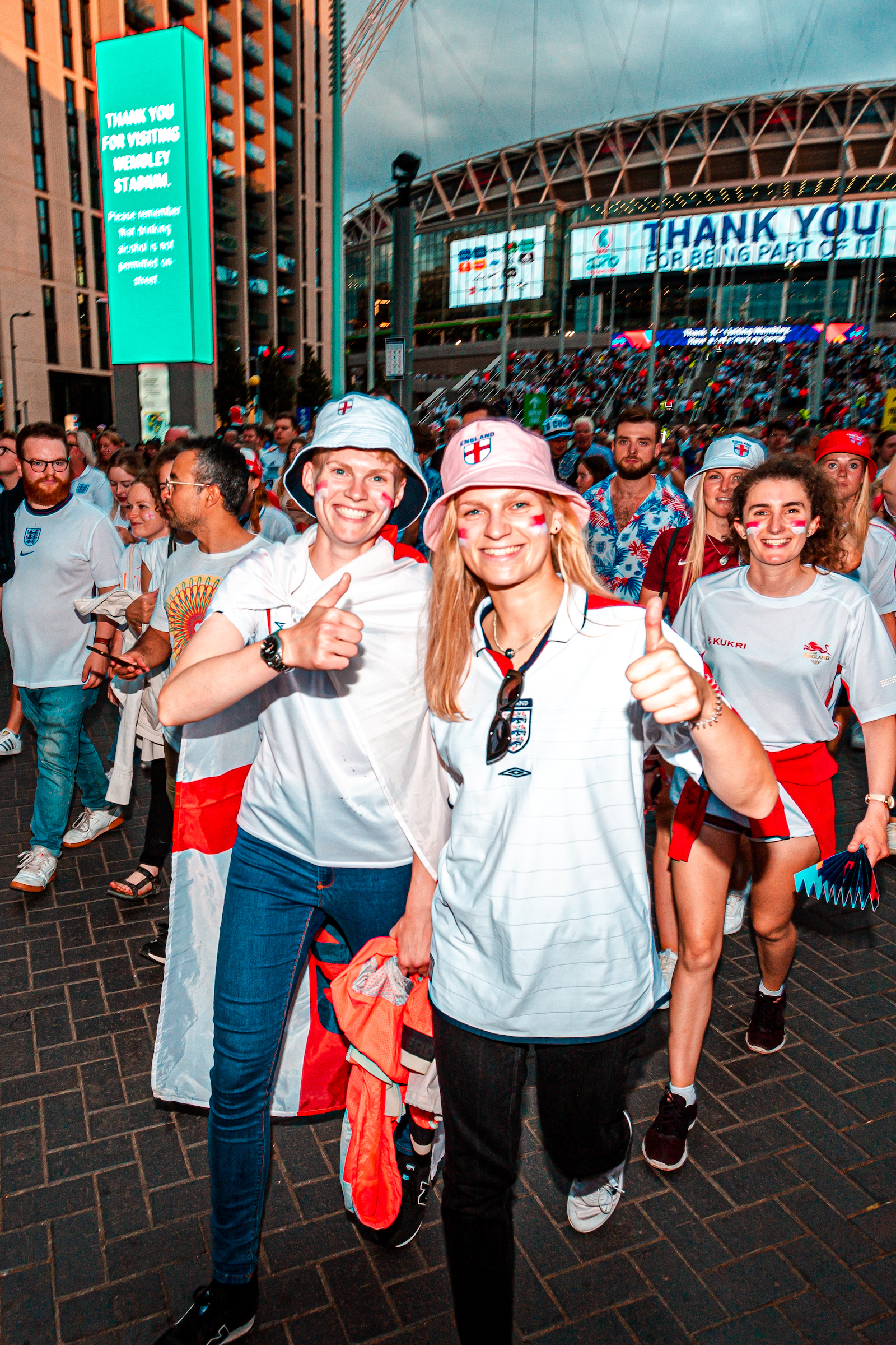 Joyful football fans outside Wembley Stadium following the Women's Euro 2022 Final