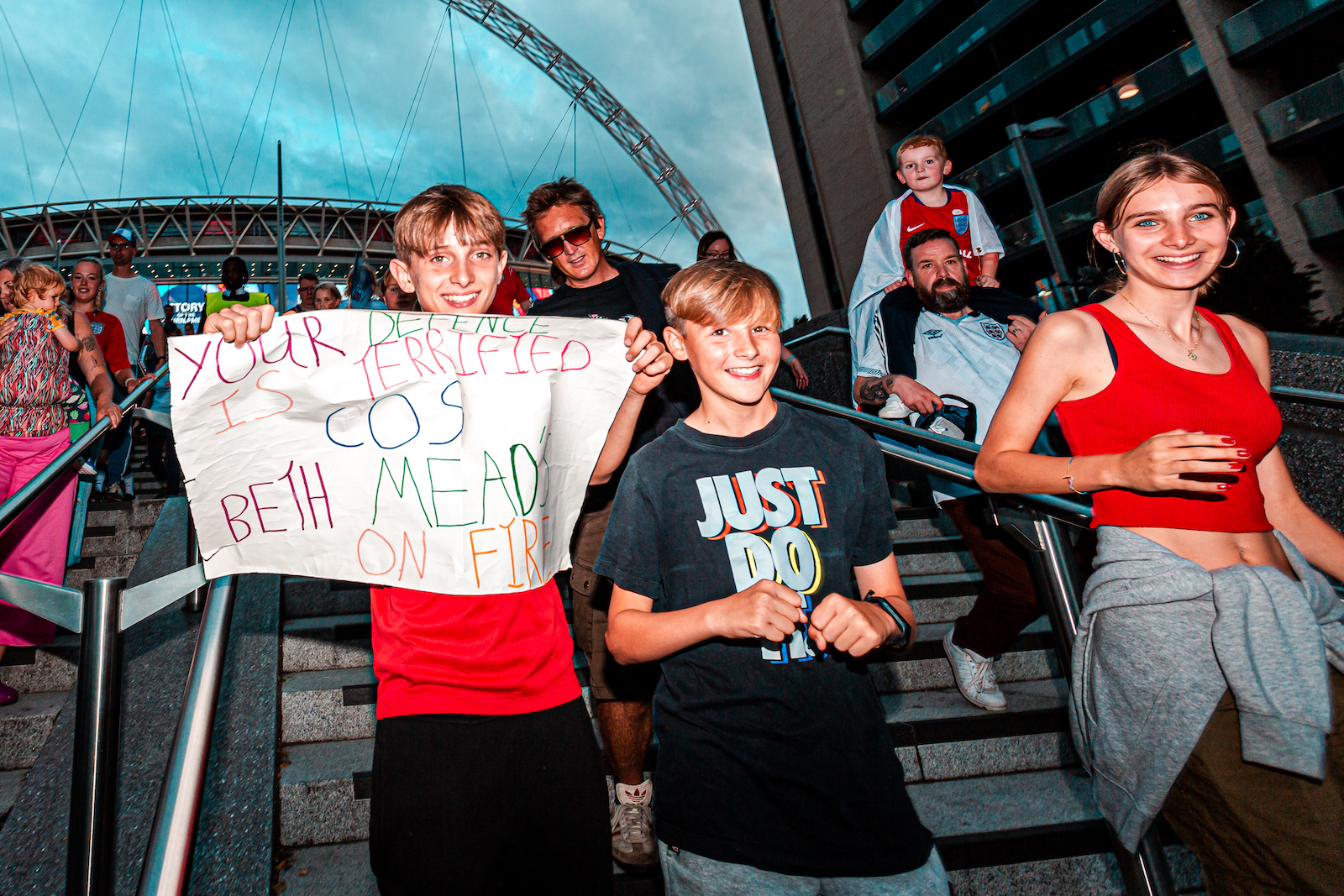 Joyful football fans outside Wembley Stadium following the Women's Euro 2022 Final