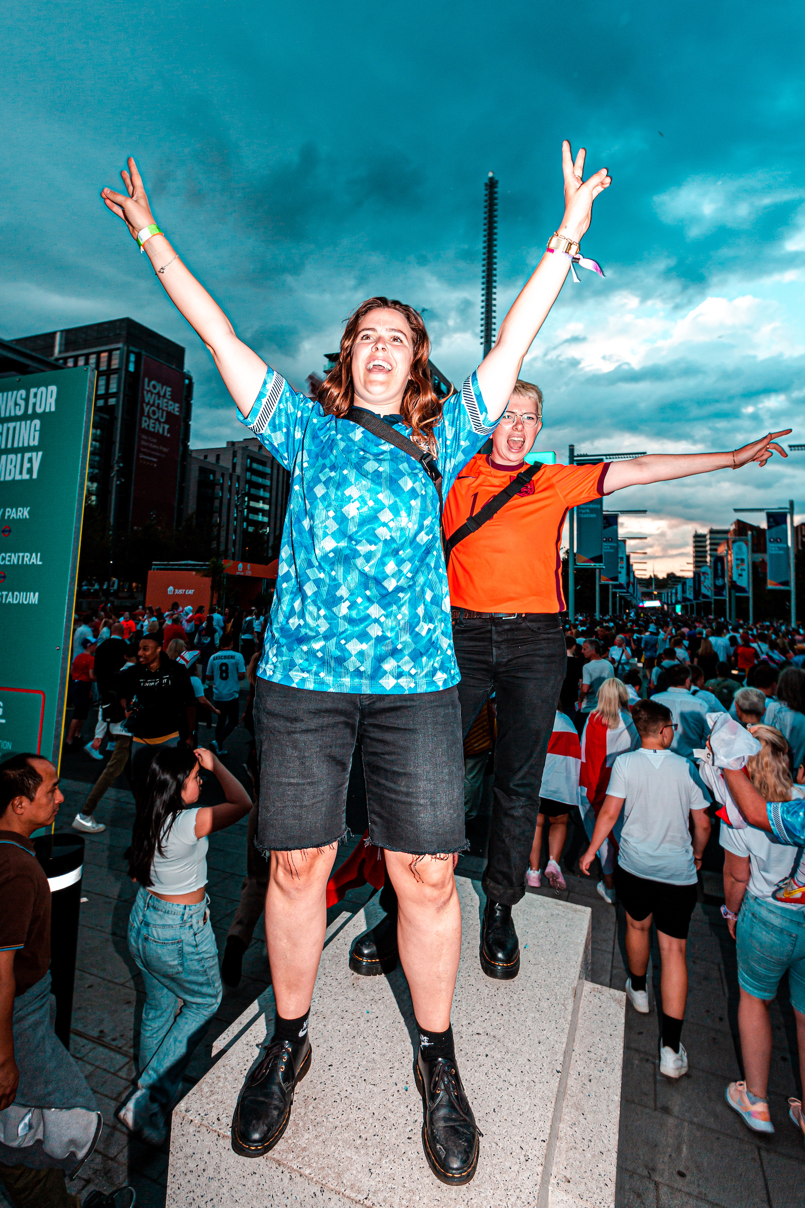 Joyful football fans outside Wembley Stadium following the Women's Euro 2022 Final