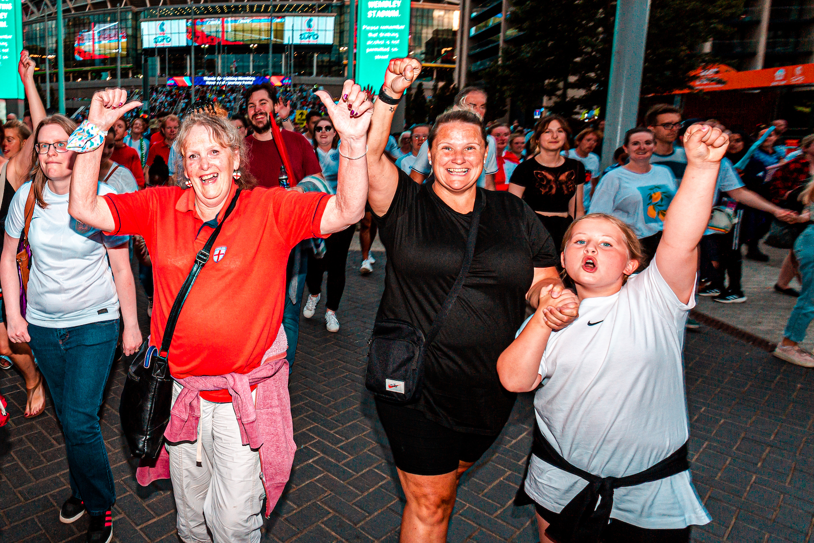 Joyful football fans outside Wembley Stadium following the Women's Euro 2022 Final