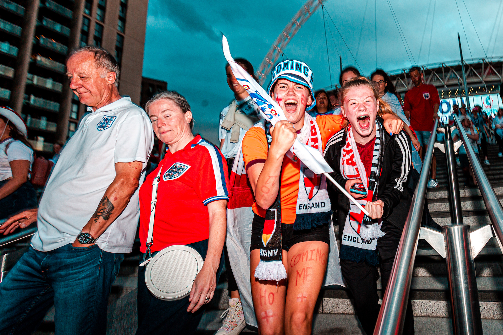 Joyful football fans outside Wembley Stadium following the Women's Euro 2022 Final