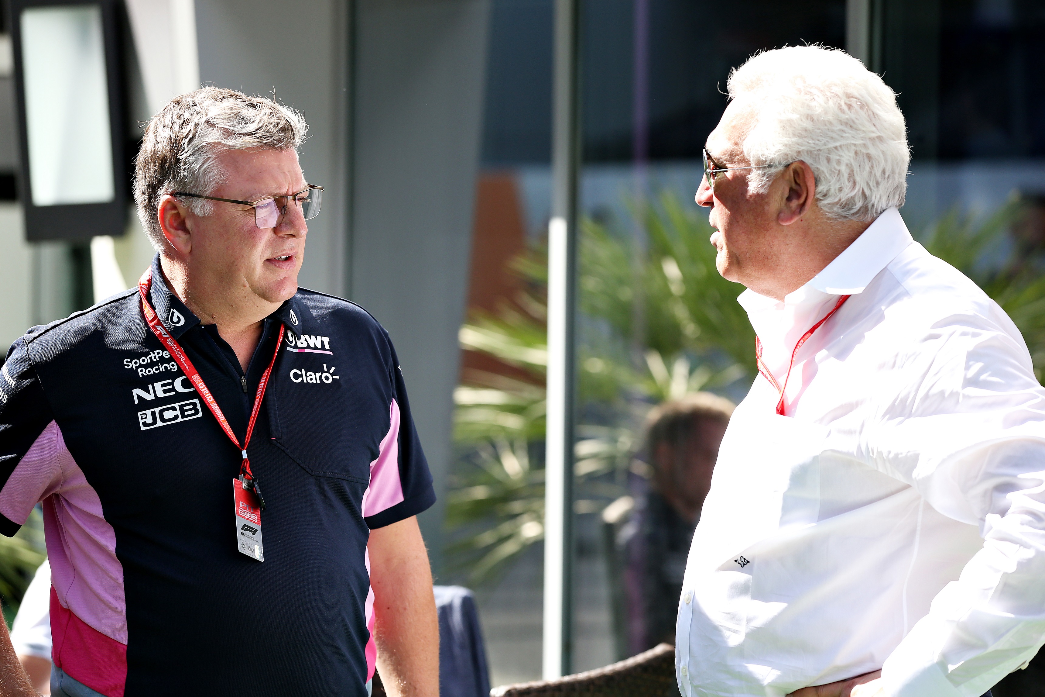 Otmar Szafnauer stares at Lawrence Stroll on a bright day.