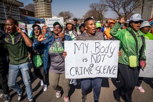 Women protest outside the Krugersdorp, South Africa, Magistrates Court Monday, Aug. 1, 2022