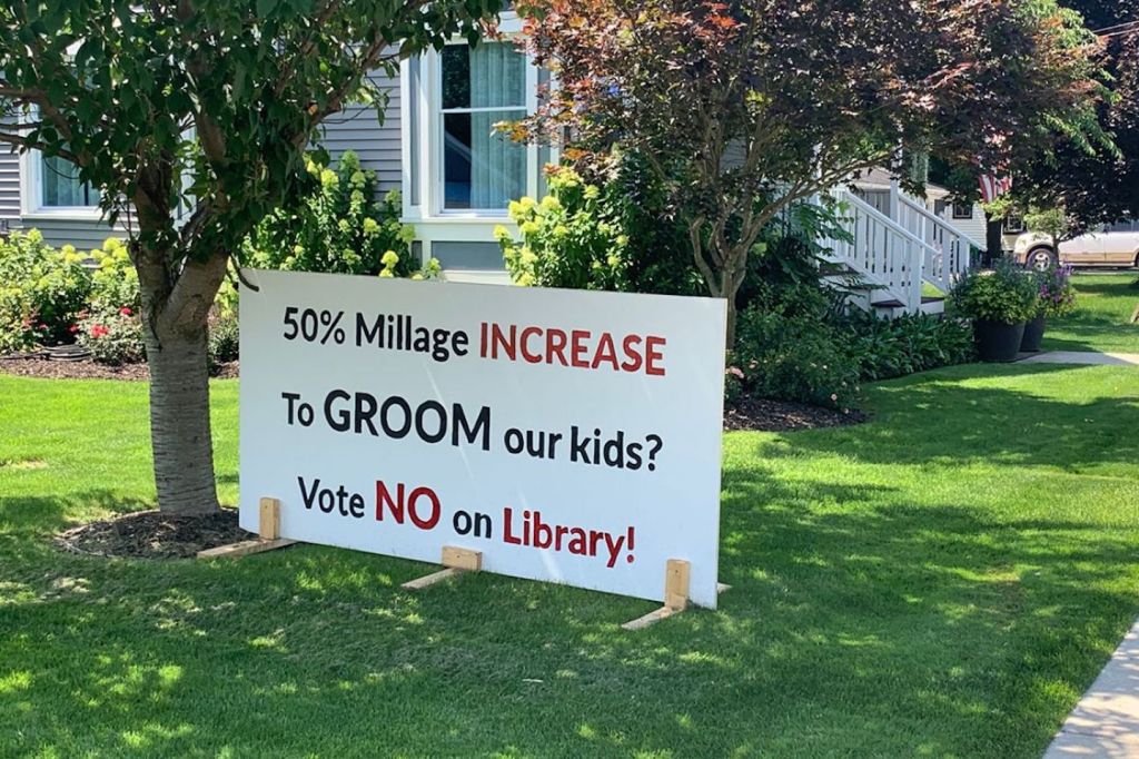 A sign on a lawn reading "50% Millage INCREASE To GROOM our kids? Vote NO on Library!"