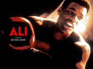 Poseter for the film"Ali," Will Smith portraying Muhammad Ali leans on the top ropes of a boxing ring.