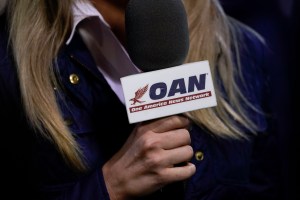 A reporter with One America News Network works at a campaign rally with President Donald Trump at Newport News/Williamsburg International Airport on September 25, 2020 in Newport News, Virginia. President Trump is scheduled to announce his nomination to t